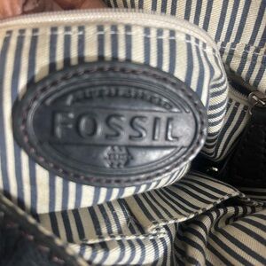 A fossil black leather woman’s cross body should bag purse.